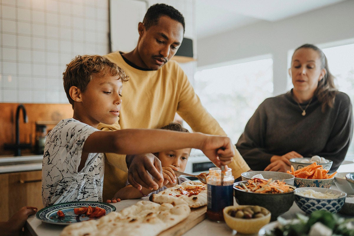 Family preparing and sharing a home meal reflecting everyday budgeting and household spending