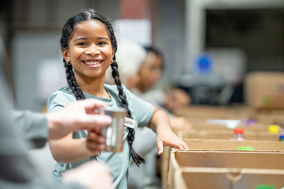 young girl volunteer smiling at the camera