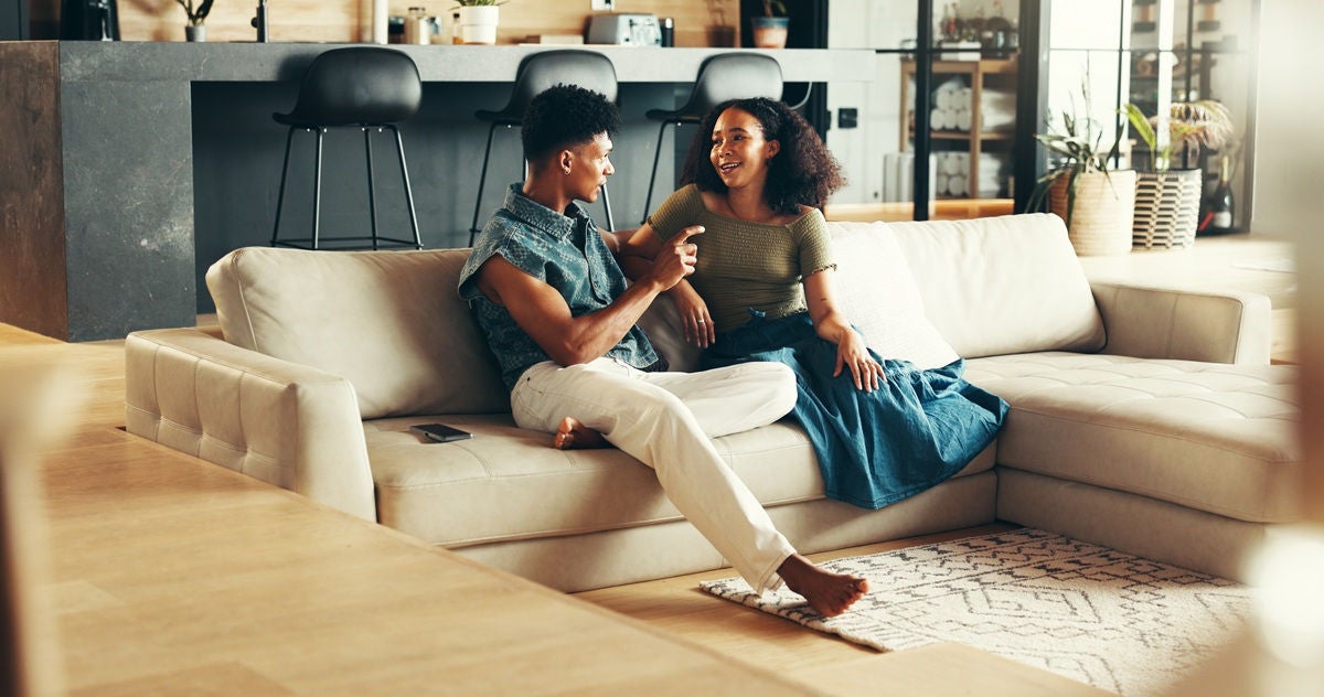 Couple discussing their finances at home while reviewing banking options