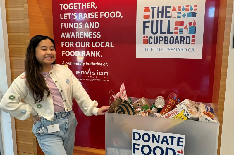 employee adding food items to a Full Cupboard donation bin