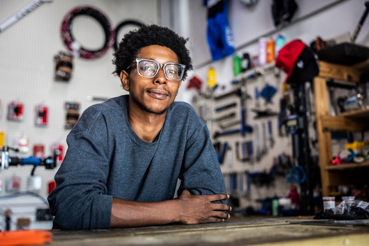 Portrait of bike shop owner leaning on counter