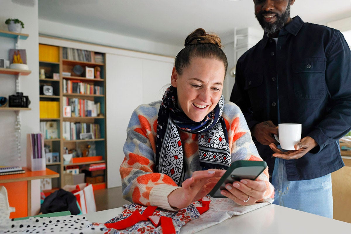 A women using her smart phone at home - mobile app