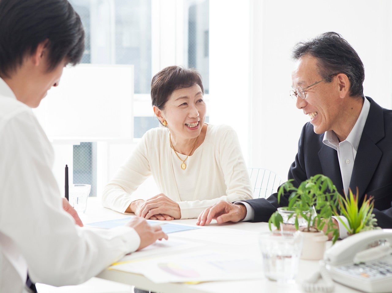 An old couple is in the process of asset management of real estate investment.