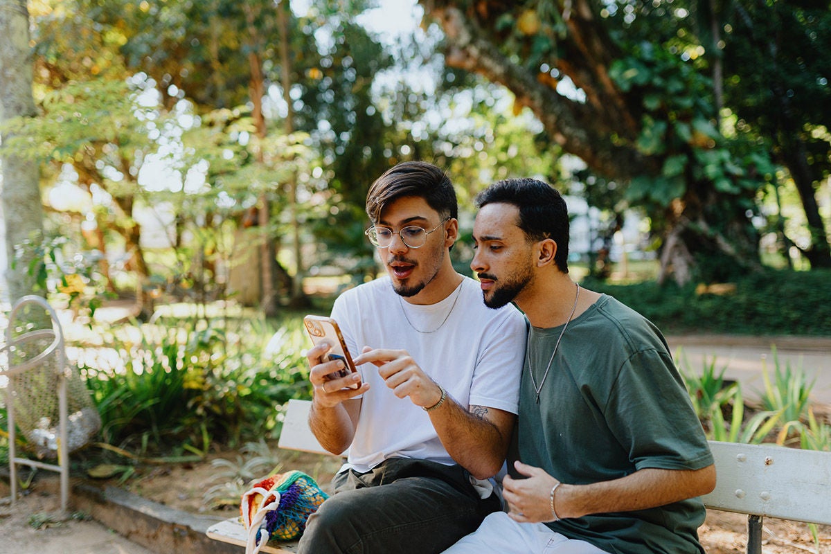 Two Men Sharing Content on Mobile Device