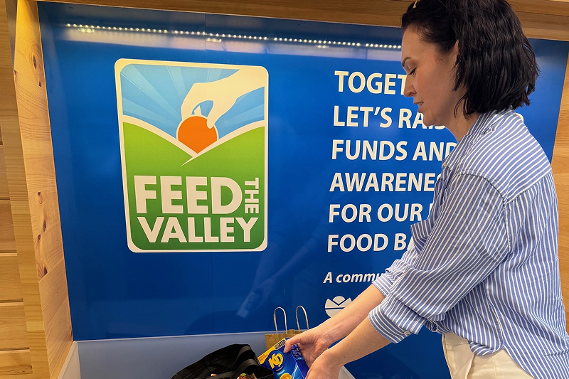 Two community workers hugging each other while volunteering