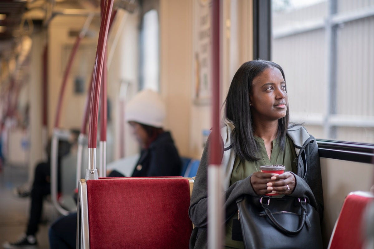 Public transit commute with coffee in hand