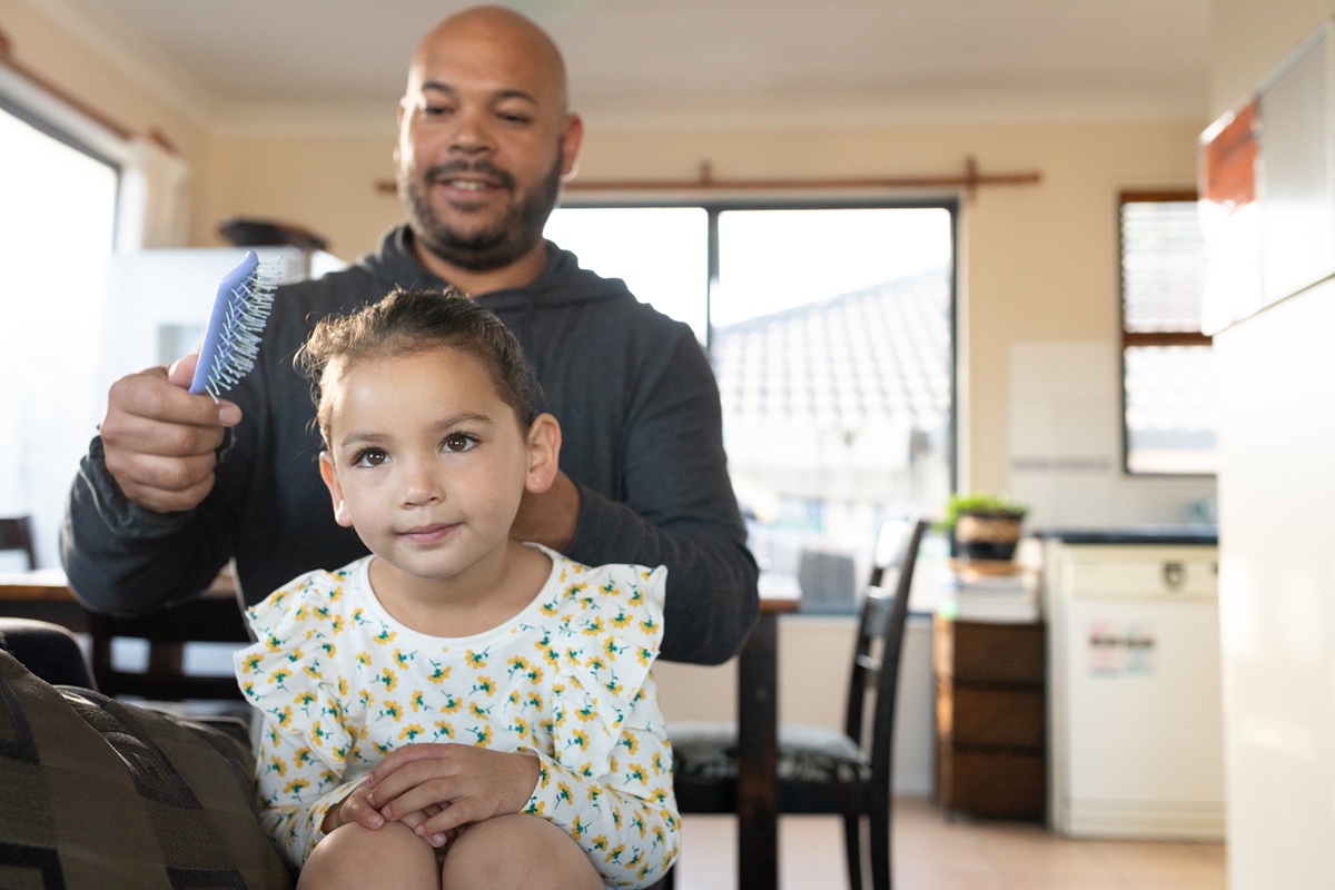 Parent caring for child at home reflecting family wellbeing and everyday financial stability