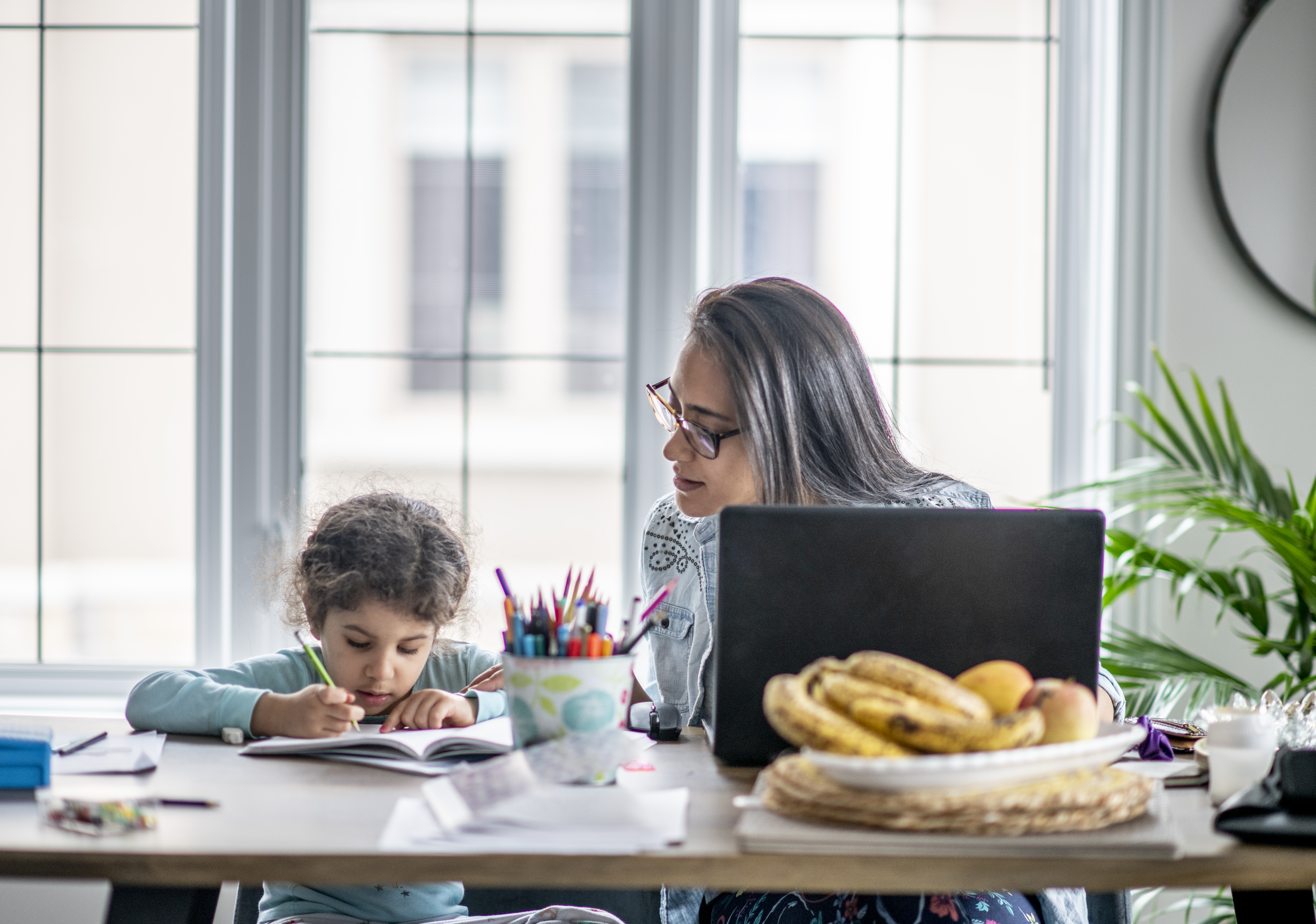 Work‑from‑home setup with parent and child learning together